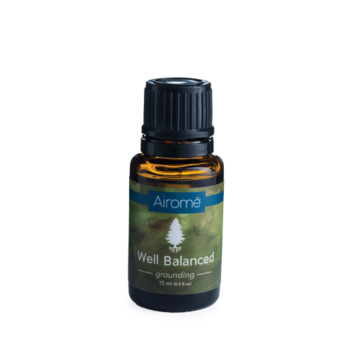 Amber glass bottle of grounding essential oil blend with black ribbed cap and green label for home scenting