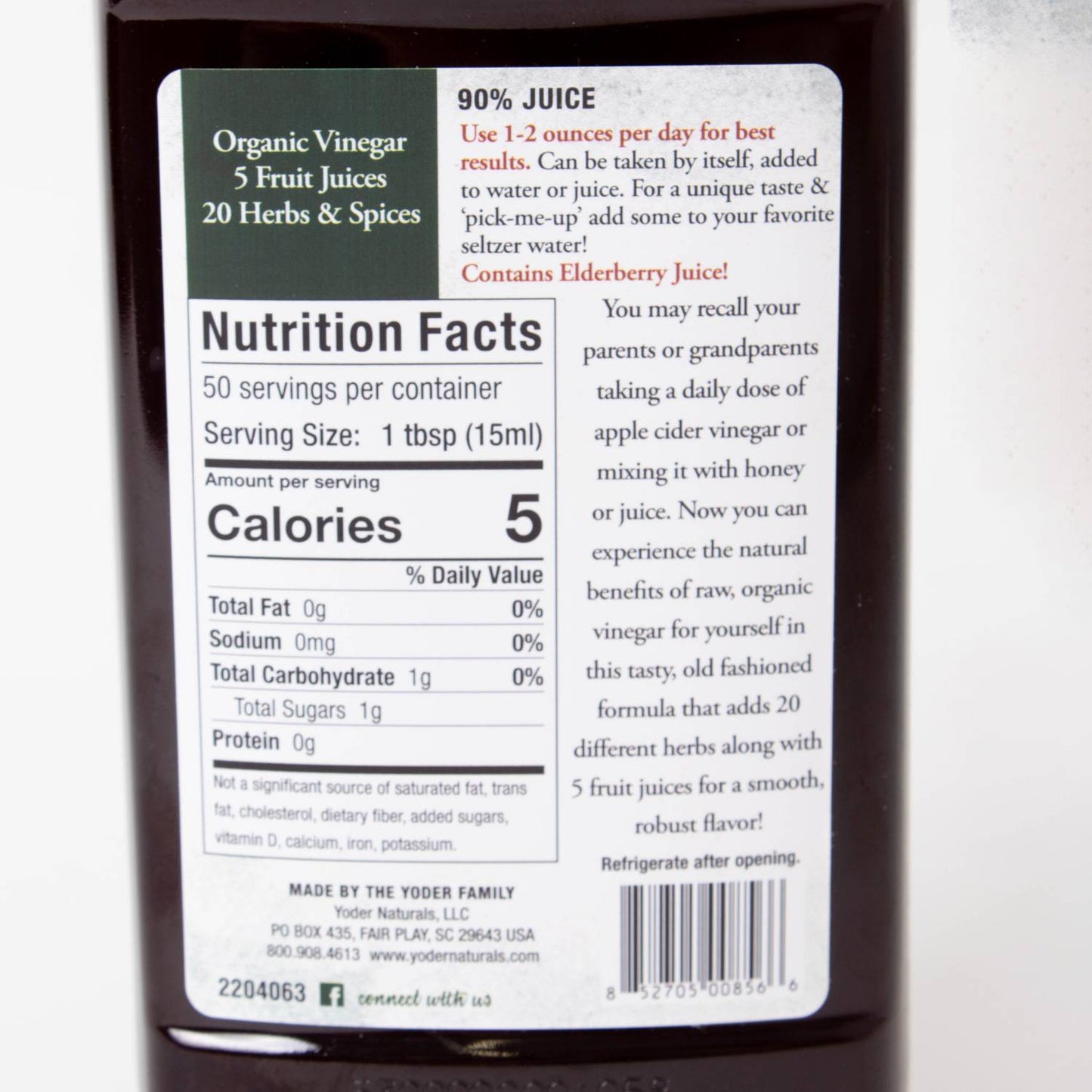 Nutrition label on dark bottle showing calorie count, serving size, and natural herbal and fruit juice ingredients details