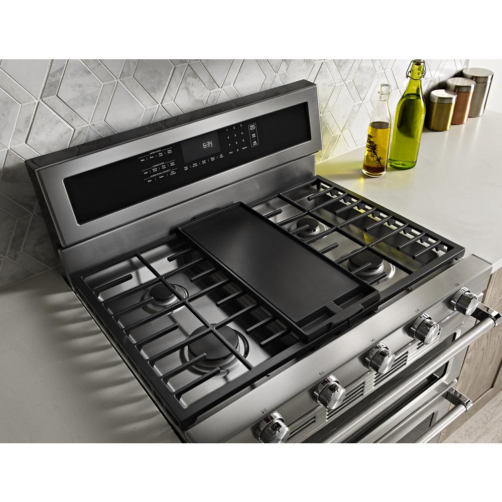 Stainless steel 5 burner gas range with griddle insert and digital control panel in modern kitchen setting