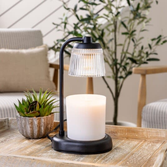 Black fluted glass candle warmer with metal stand, designed for safe candle heating in home improvement settings