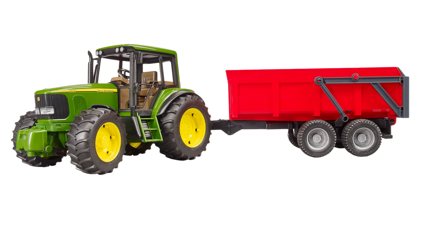 Green toy tractor with large tires attached to a red tipping trailer for realistic farm play scenarios
