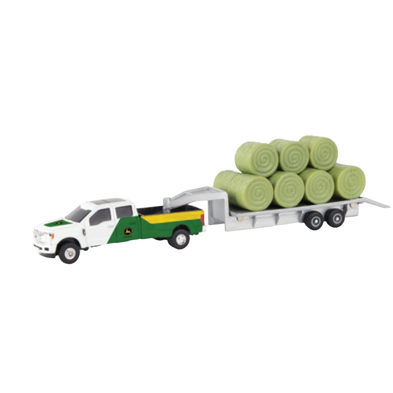 Green and white toy pickup truck with trailer carrying multiple round bales for farm and home display use