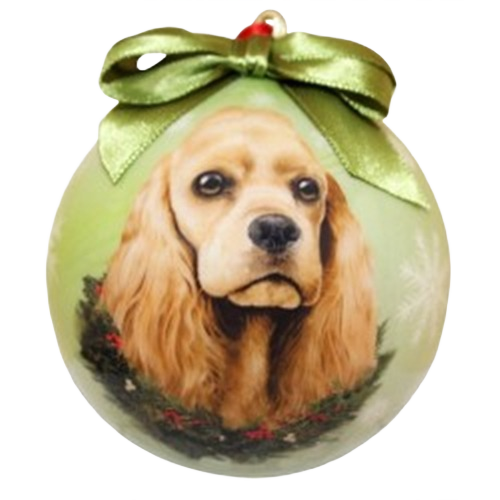 Buff-colored Cocker Spaniel portrait on a green Christmas ball ornament with holiday wreath and ribbon bow.
