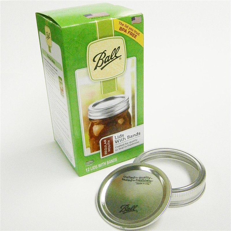 Green packaging of Ball canning lids with bands alongside unopened and open metal lid components for home use