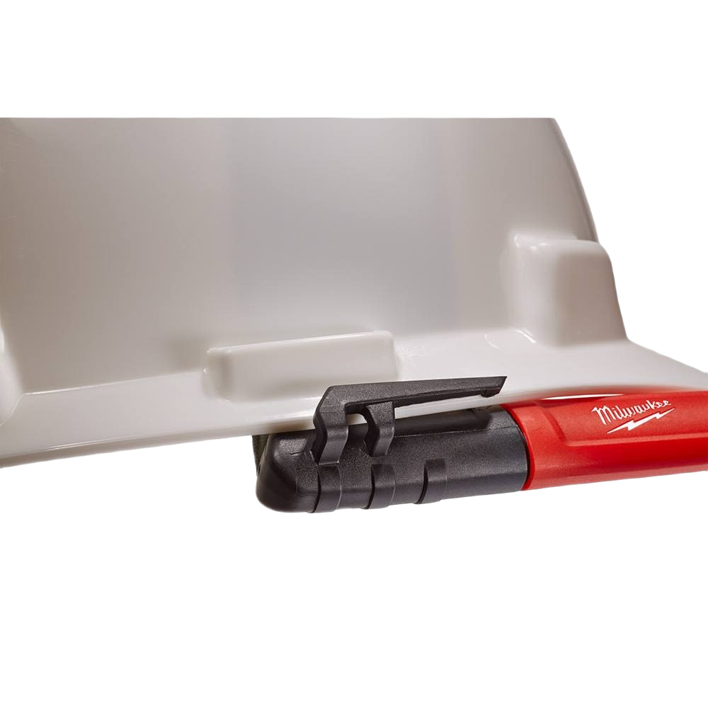 Close-up of a red and black Milwaukee tool part attached to a light gray plastic surface, used for home improvement tasks