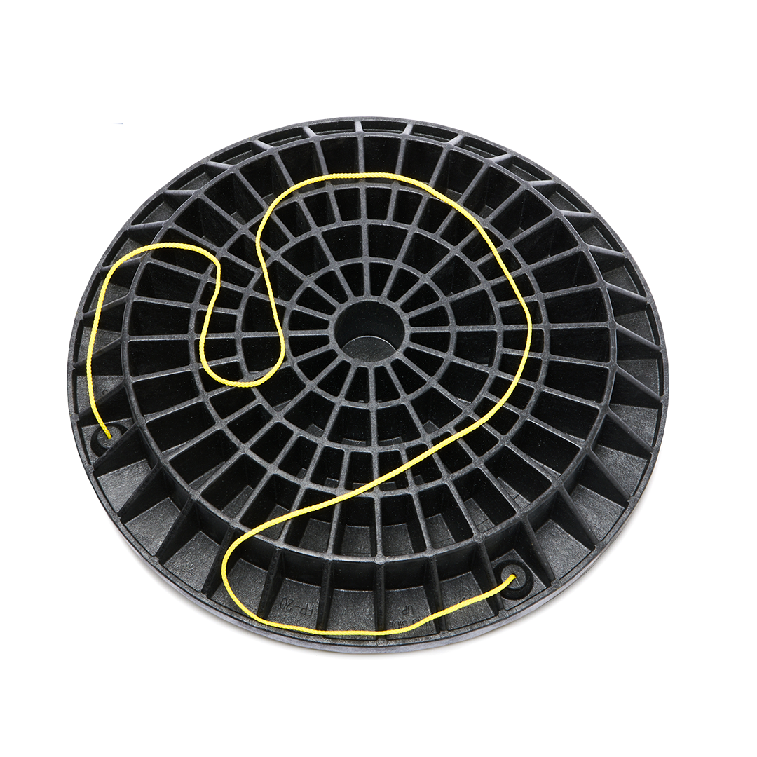 Black composite footing pad with grid structure and yellow string for leveling in home improvement projects
