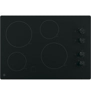 Black electric cooktop with four burners and knob controls in kitchen appliance for home improvement and cooking tasks
