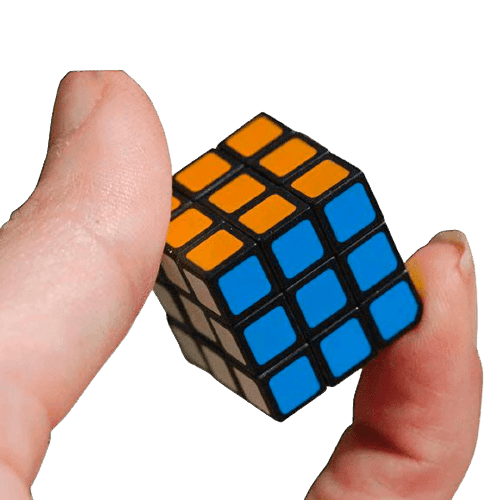 Hand holding a tiny 3x3 cube puzzle with blue, orange, and white squares representing a miniature Rubik’s Cube toy