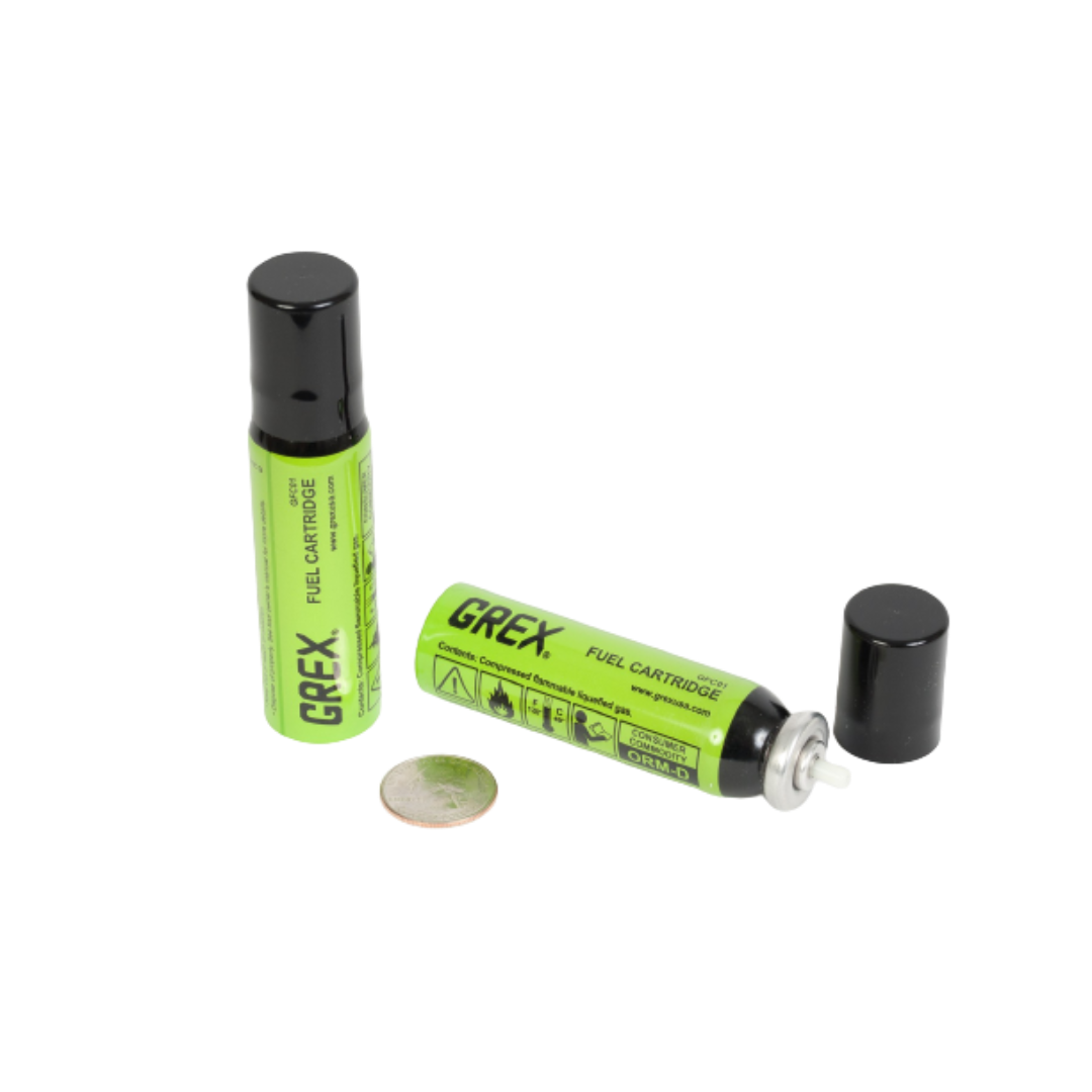 Green fuel cartridges with black caps for cordless tools and home improvement applications shown alongside a coin for scale