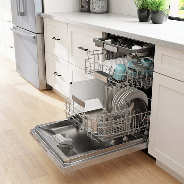 Open stainless steel dishwasher loaded with clean dishes inside a modern kitchen with light cabinetry and hardwood floor