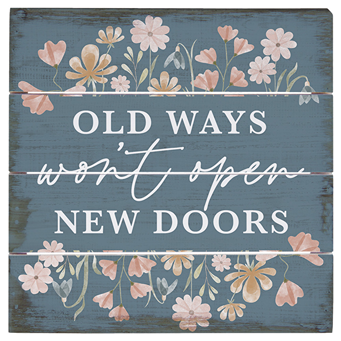Decorative wooden pallet sign with floral accents and inspirational phrase in white on blue background