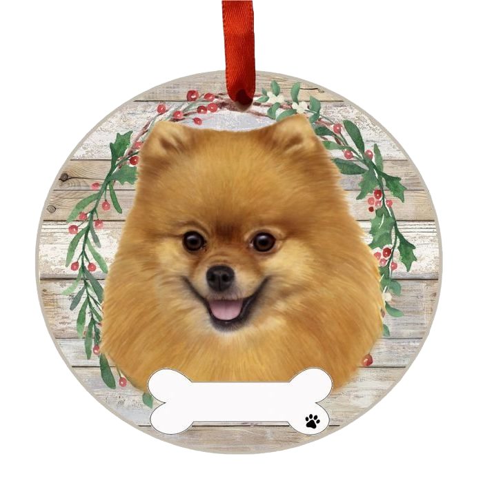 Round Christmas ornament with a smiling Pomeranian face framed by a green and red festive wreath and red loop