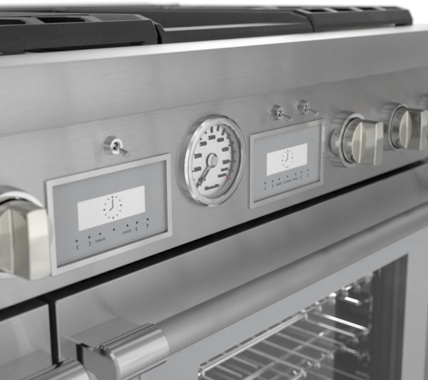 Close-up of stainless steel control panel on professional dual fuel range with analog temperature gauge and digital displays