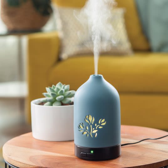 Blue ultrasonic essential oil diffuser with floral cutout design for calming home decor under $50 collection
