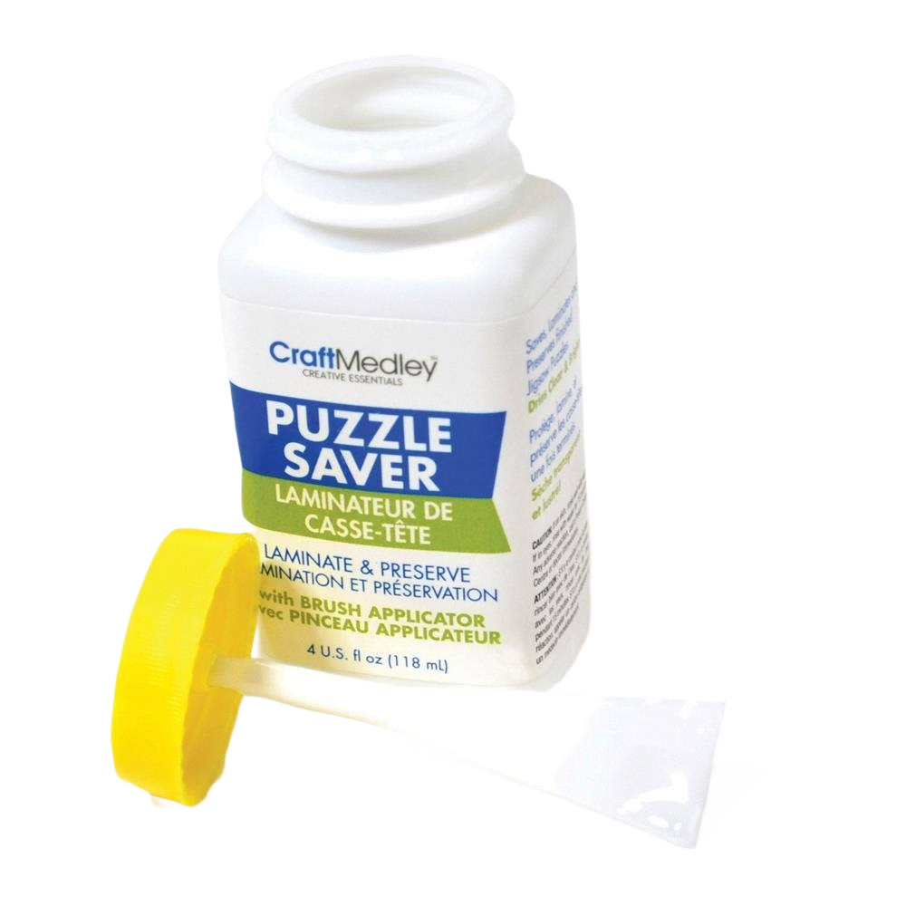 White container of puzzle saver glue with blue and green label and yellow brush applicator for preserving puzzles