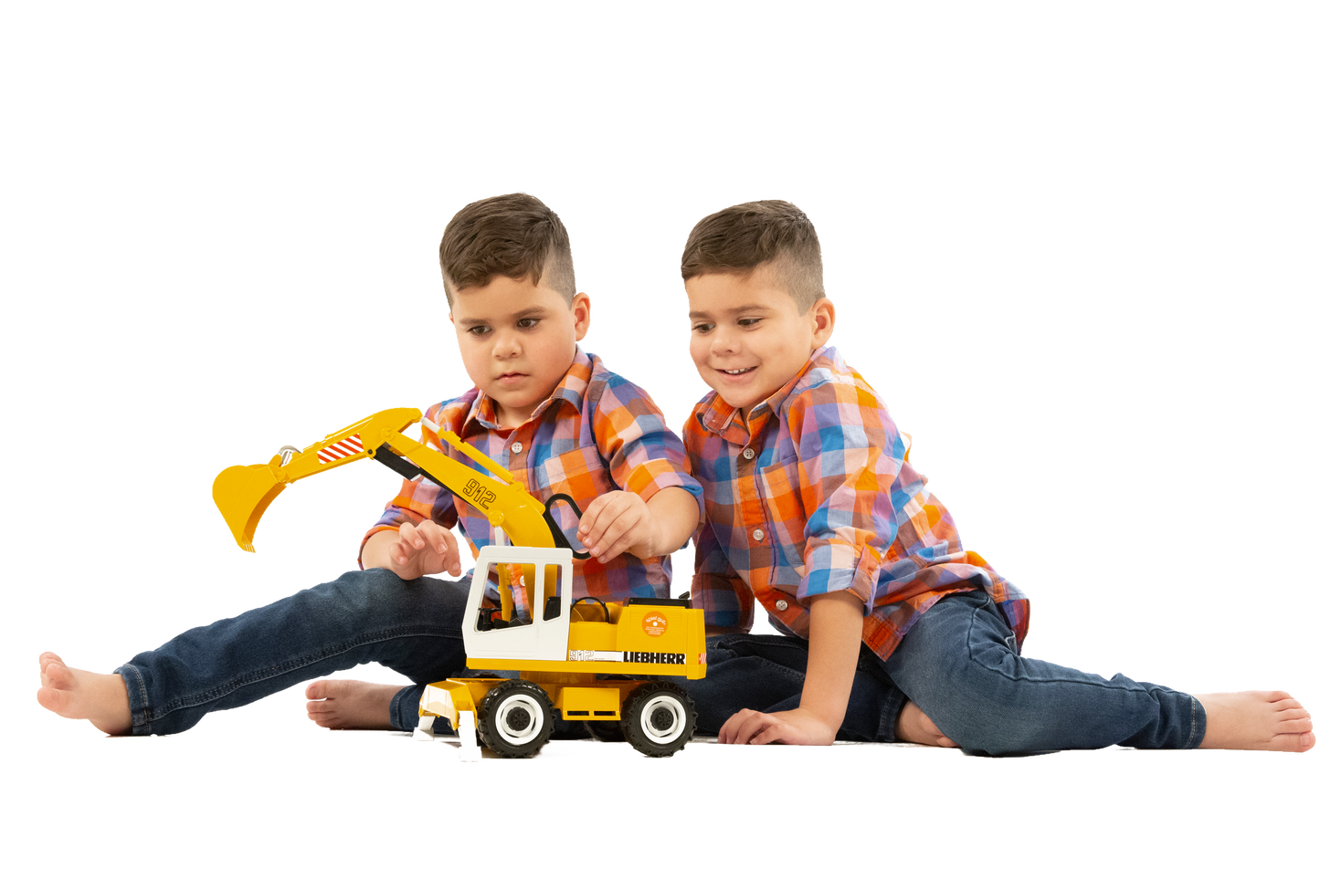 Two boys playing on floor with yellow Bruder Liebherr Power Shovel toy from Vehicles & Remote Controlled Toys collection