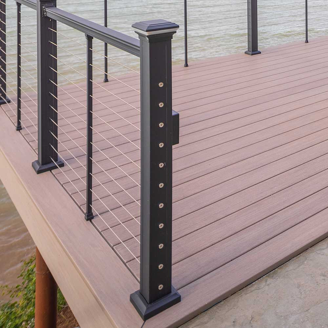 Black metal deck post with horizontal cable railing and decorative cap for home improvement projects