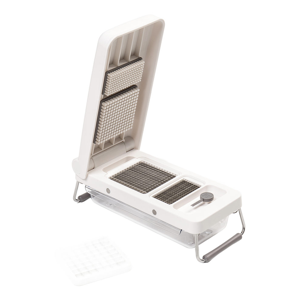 White durable kitchen chopper with interchangeable grid blades and sturdy metal frame in minimalist kitchenware setting