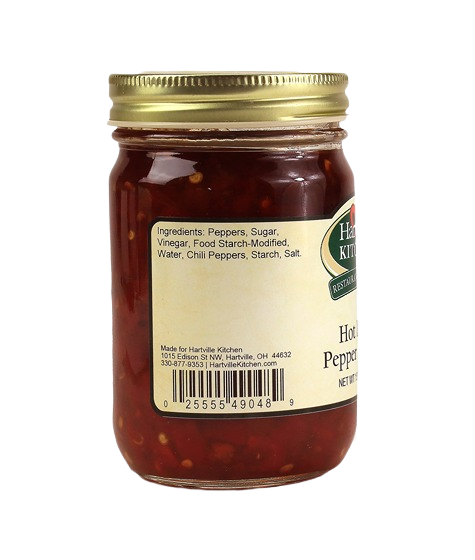 Glass jar of spicy red pepper relish with gold metal lid and ingredient label for kitchen pantry use