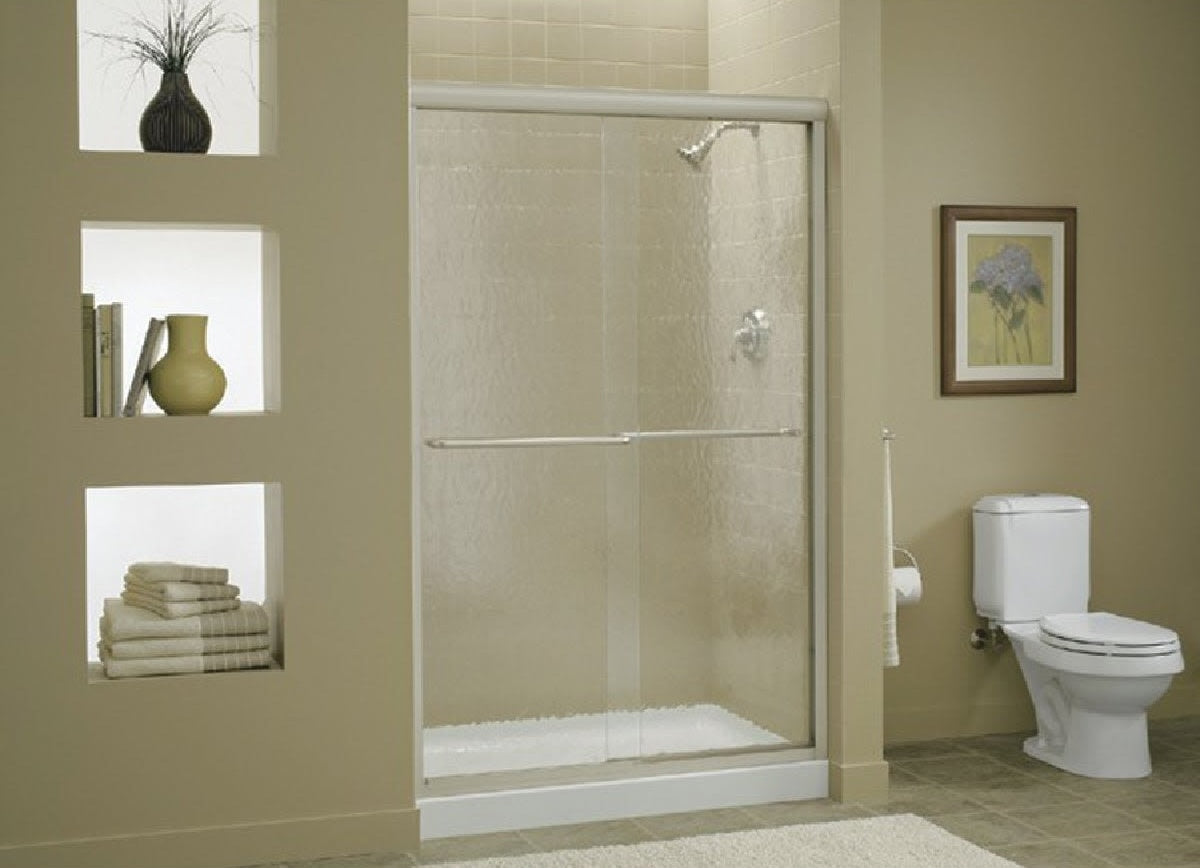 Modern frameless sliding shower door with clear glass and chrome frame in stylish bathroom setting