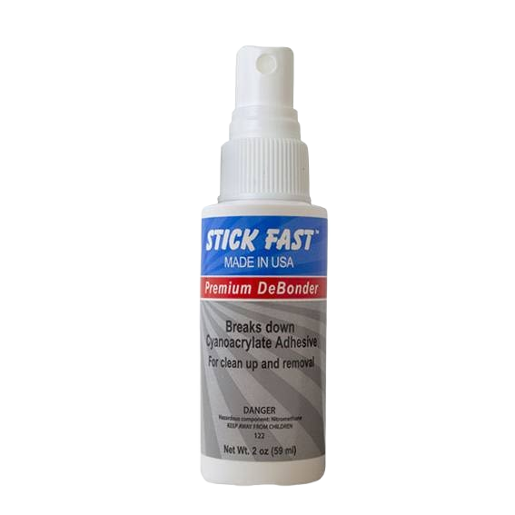 Small white spray bottle of premium debonder designed to break down cyanoacrylate adhesive for easy removal.