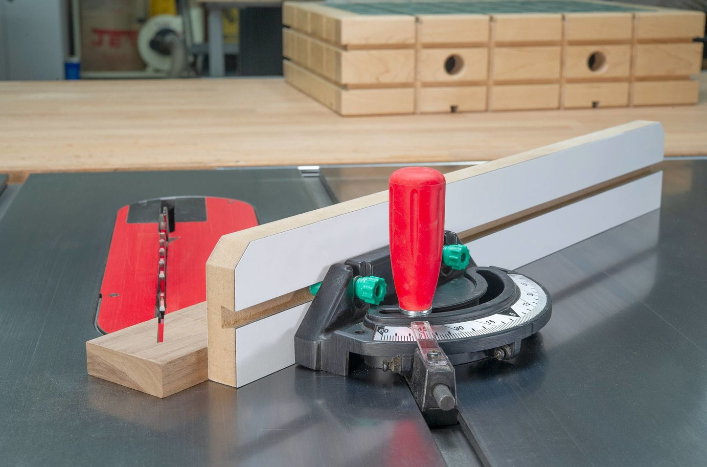 Table saw miter gauge with red handle and adjustable fence for precise angled cuts in woodworking tool accessories