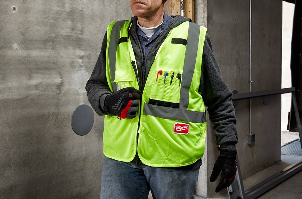 High visibility yellow Milwaukee vest with multiple pockets and reflective striping for tools and home improvement tasks