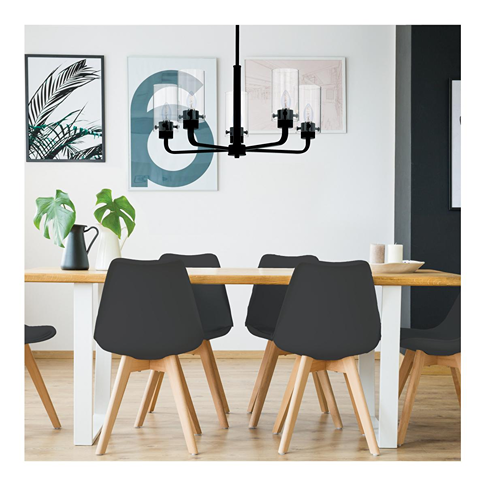 Modern dining room with black candelabra chandelier featuring clear glass bulbs and warm ambient lighting under $50
