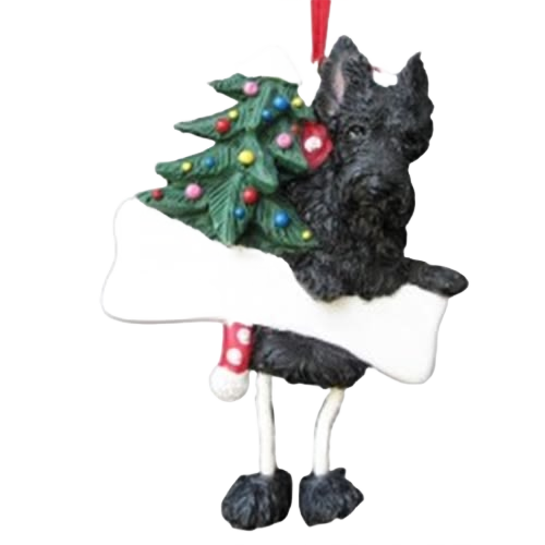 Black Scottie dog ornament with dangling legs holding a decorated Christmas tree and white bone-shaped sign