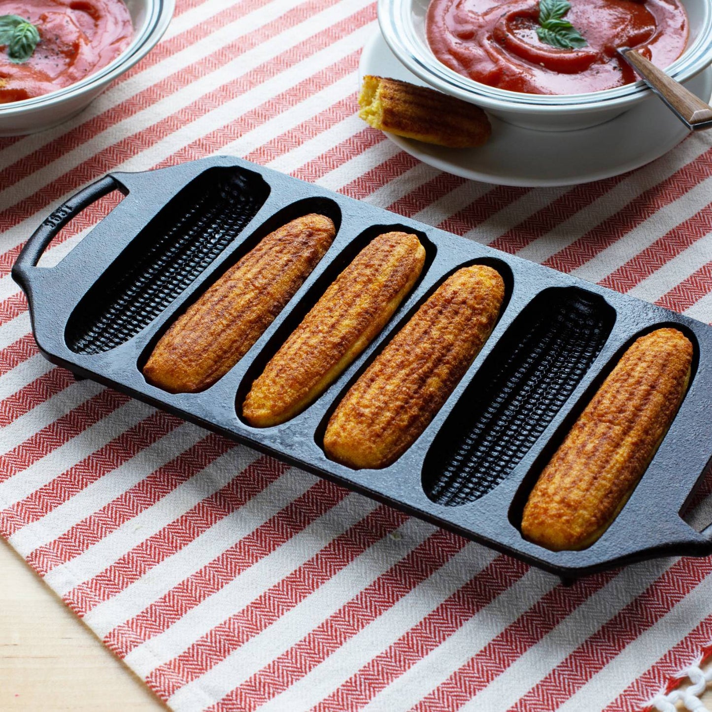 Six-slot cast iron cornstick pan with textured molds and handles in kitchenware and Lodge Cast Iron collections