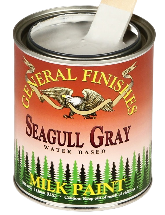 Open quart can of water-based gray milk paint with wooden stir stick for specialty paint and home improvement collections
