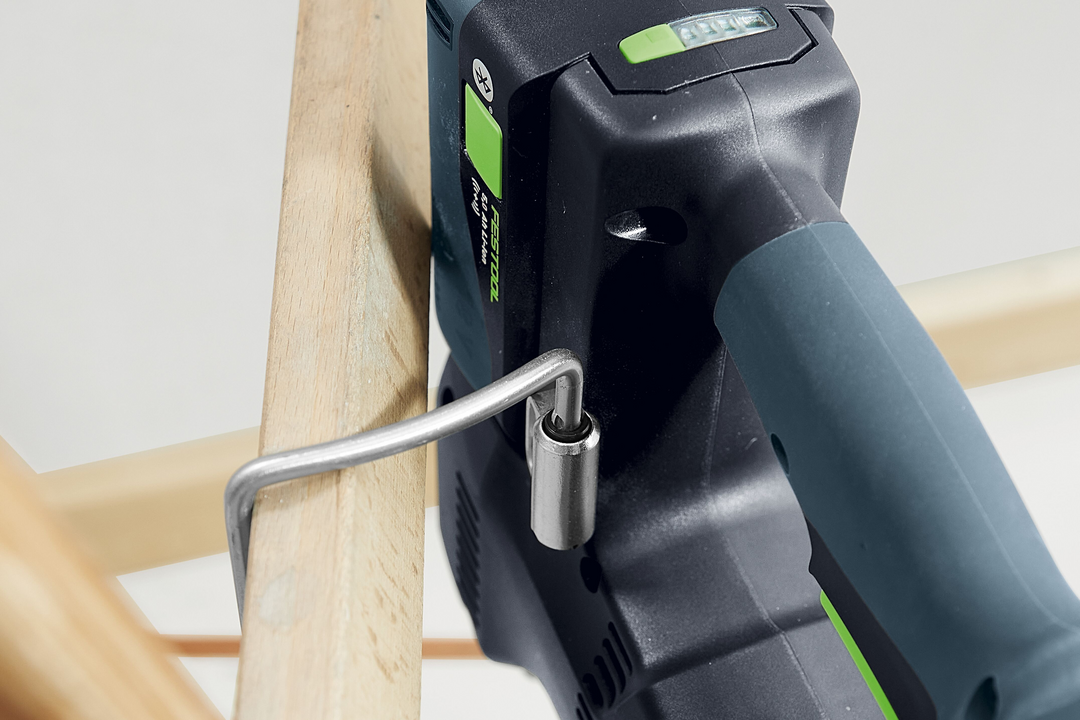 Cordless rotary hammer drill with ergonomic handle tightening hex key on wooden furniture for woodworking tools collection