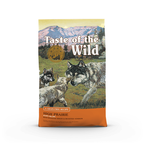Bag of Taste of the Wild dry puppy food featuring wild wolves illustration and mountain landscape background