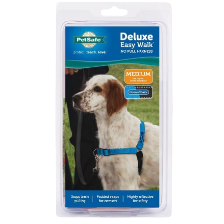 Blue and black medium-sized no-pull dog harness with padded straps and reflective safety features in packaging