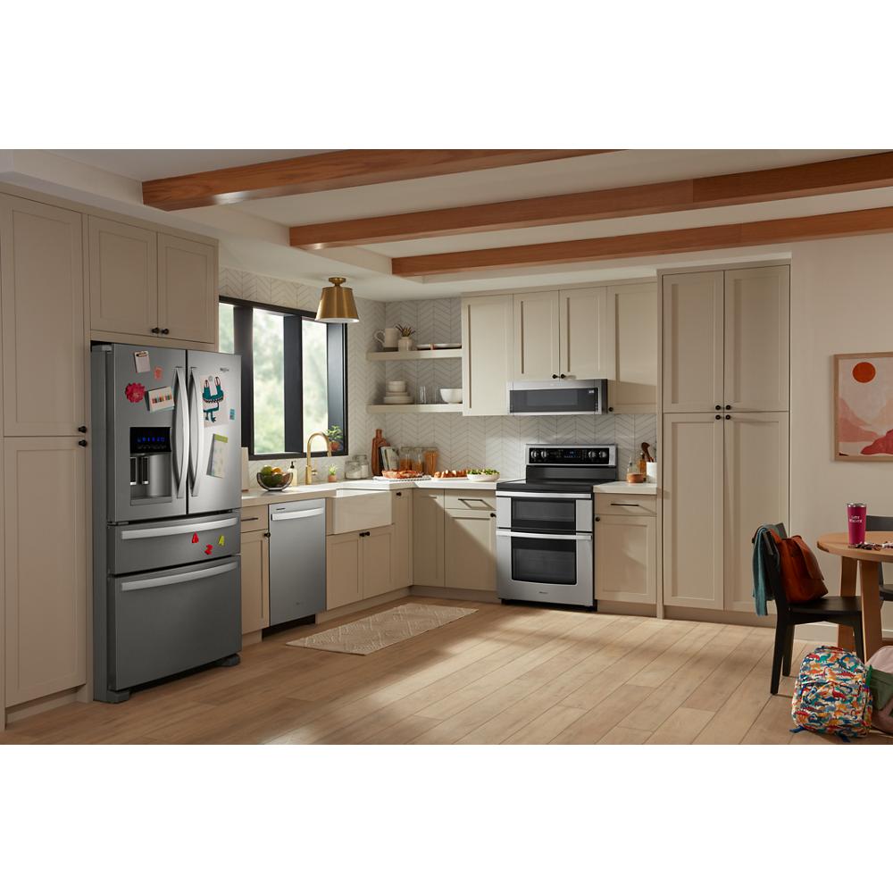 Kitchen with beige cabinetry and stainless steel appliances including a double oven electric range and french door refrigerator