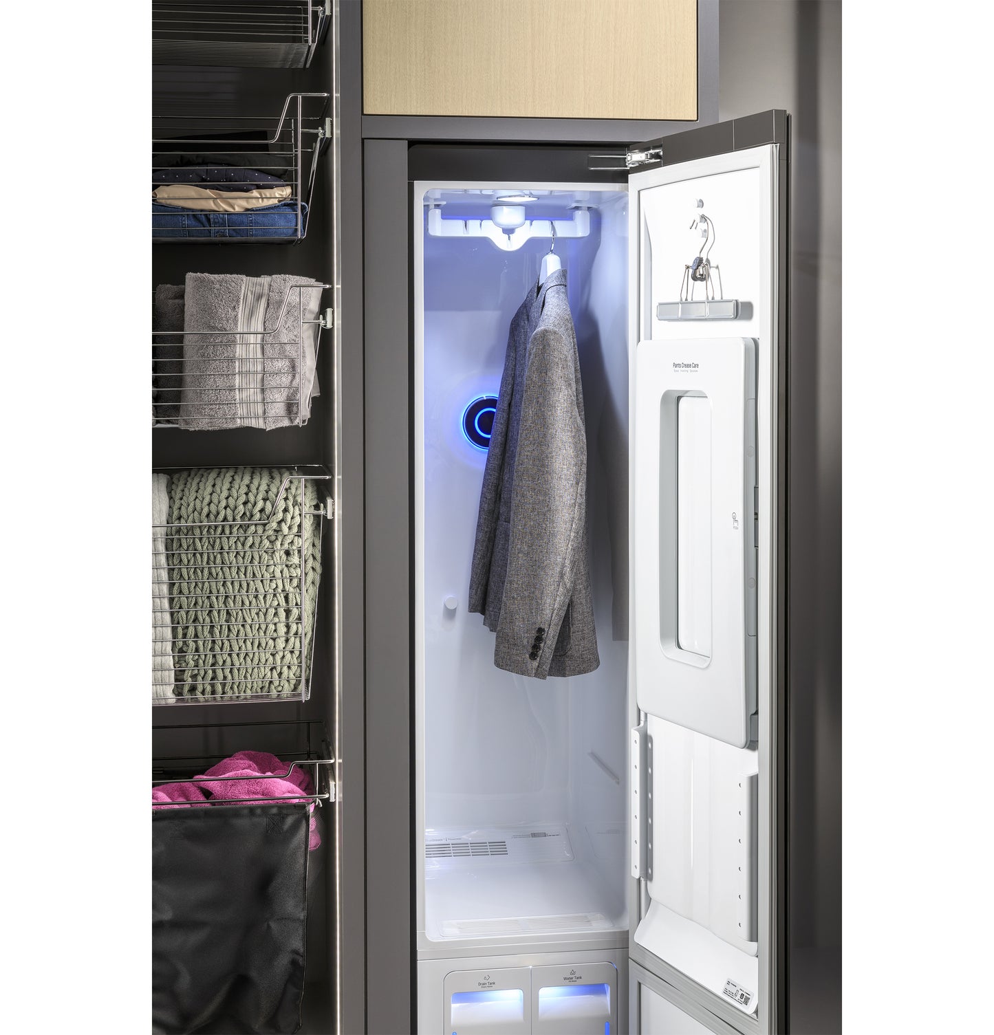 Open GE Profile steam closet with interior lighting refreshing a gray jacket in a modern appliance laundry center