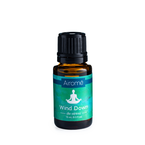 Amber glass bottle of Airome Wind Down essential oil with blue and green label and black plastic cap for relaxation use