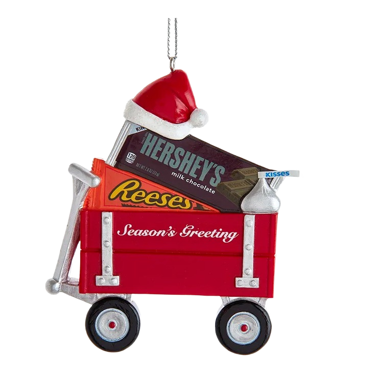 Red wagon ornament holding Hershey's, Reese's, and Kisses chocolates with a festive Santa hat on top