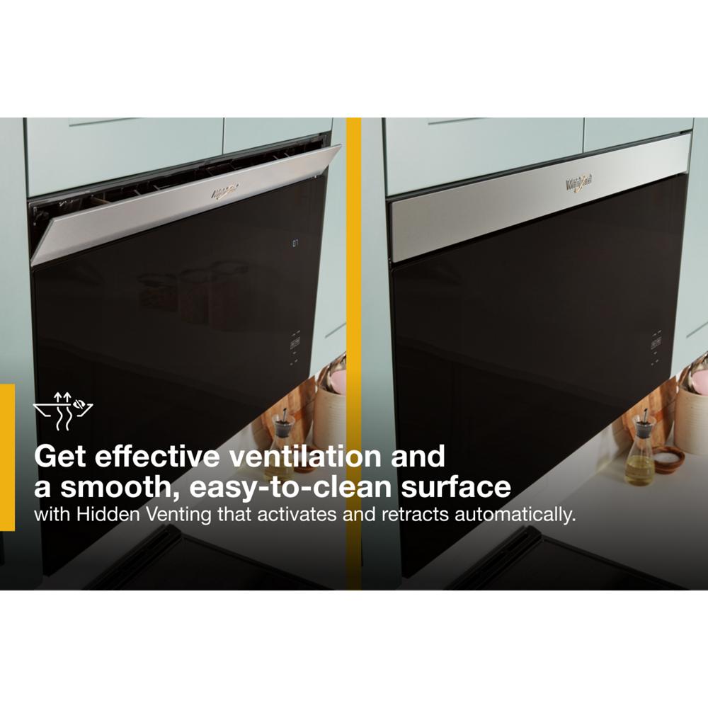 Black dishwasher with stainless steel handle installed under light blue cabinetry, showcasing hidden ventilation feature in kitchen