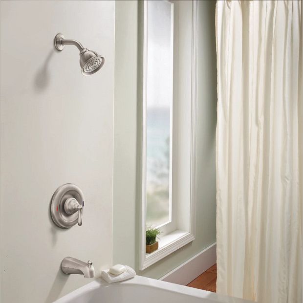 Brushed nickel showerhead and tub faucet trim with lever handle in a bathroom setting with window and shower curtain
