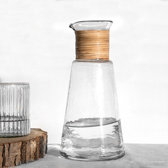 Clear glass taper carafe with natural caning detail, ideal for tableware and kitchenware collections under 50 dollars