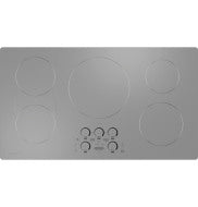 Stainless steel 36-inch induction cooktop with five cooking zones and front control knobs in kitchen appliances setting