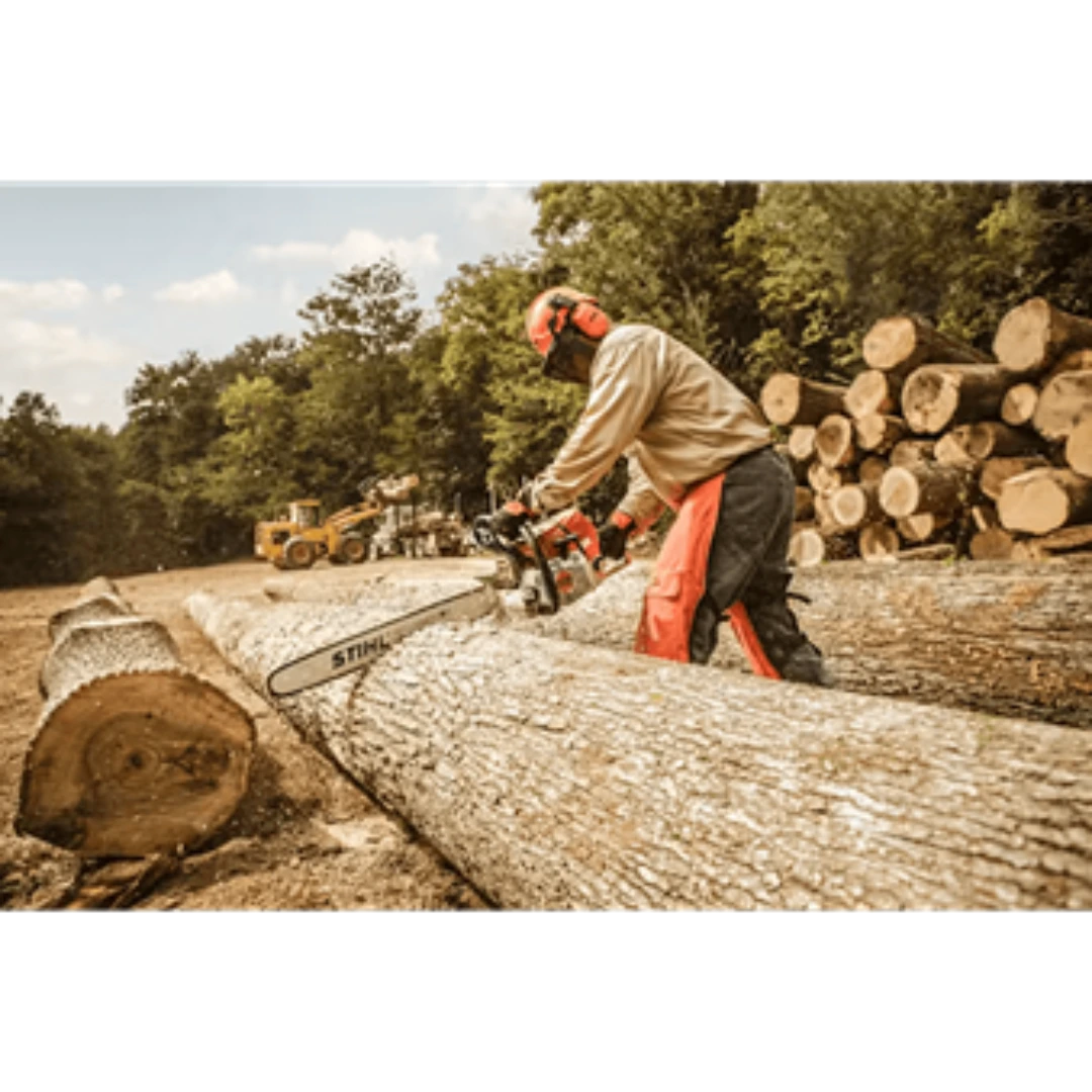 Worker wearing safety gear operating a gas-powered chainsaw cutting large logs in an outdoor woodcutting setting