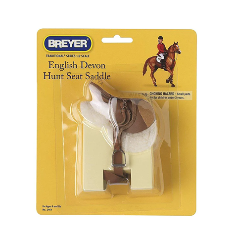 Miniature English-style hunt seat saddle model on yellow packaging with illustration of rider and horse