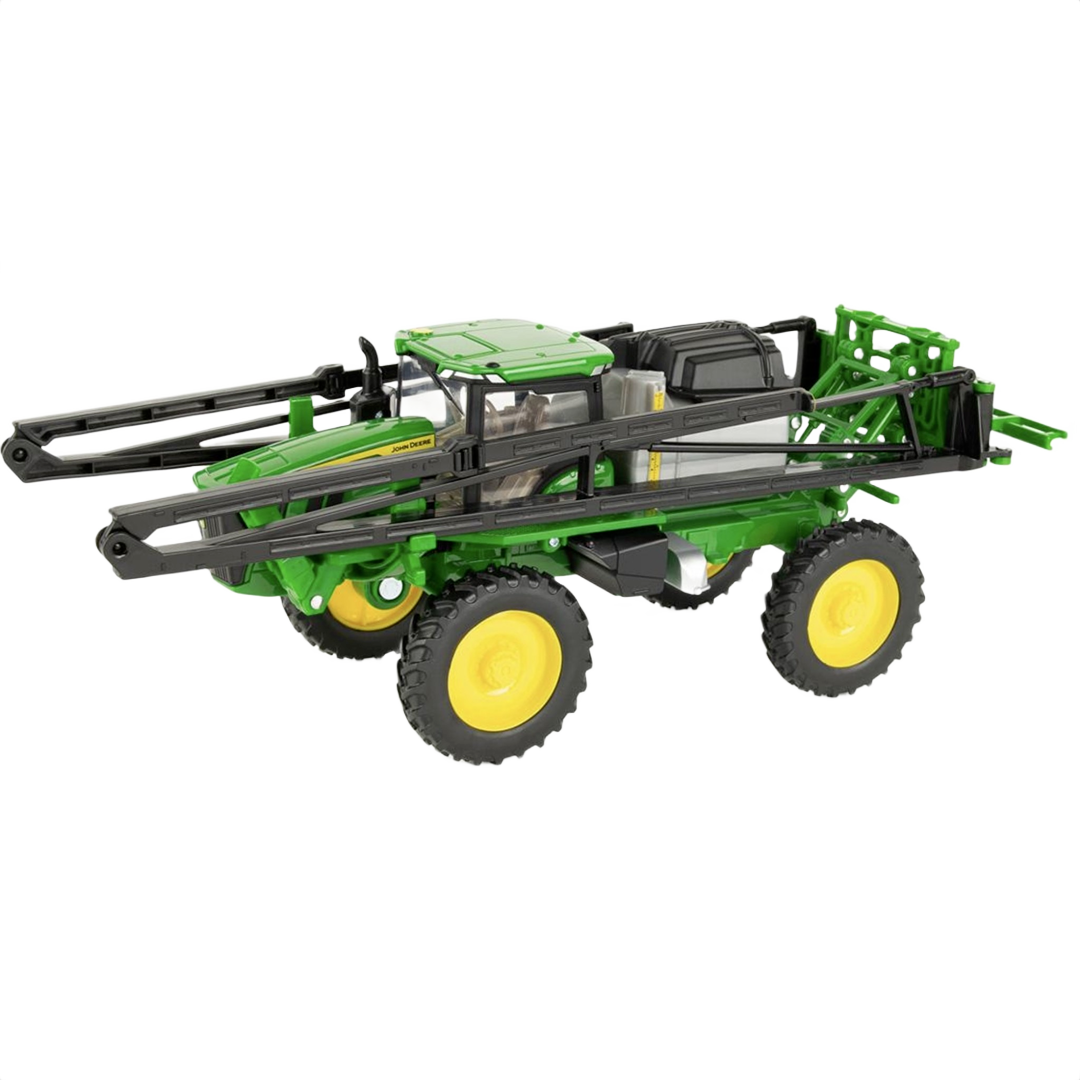 Green and yellow toy agricultural sprayer with extendable black booms and yellow-rimmed wheels for farming play