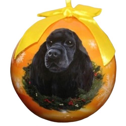 Orange Christmas ball ornament featuring a black cocker spaniel portrait with festive wreath and yellow ribbon topper