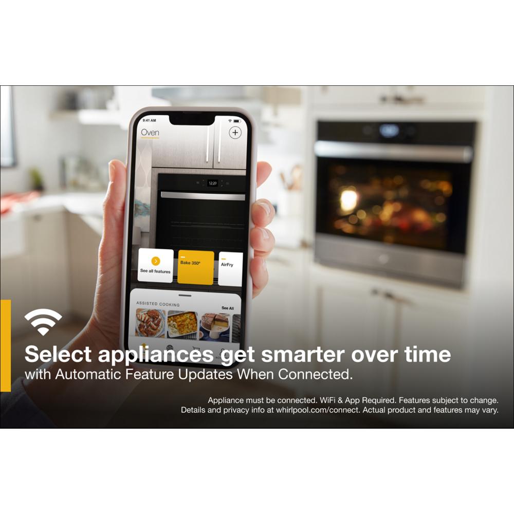 Smart control interface on phone managing a built-in black wall oven in a modern kitchen appliances collection