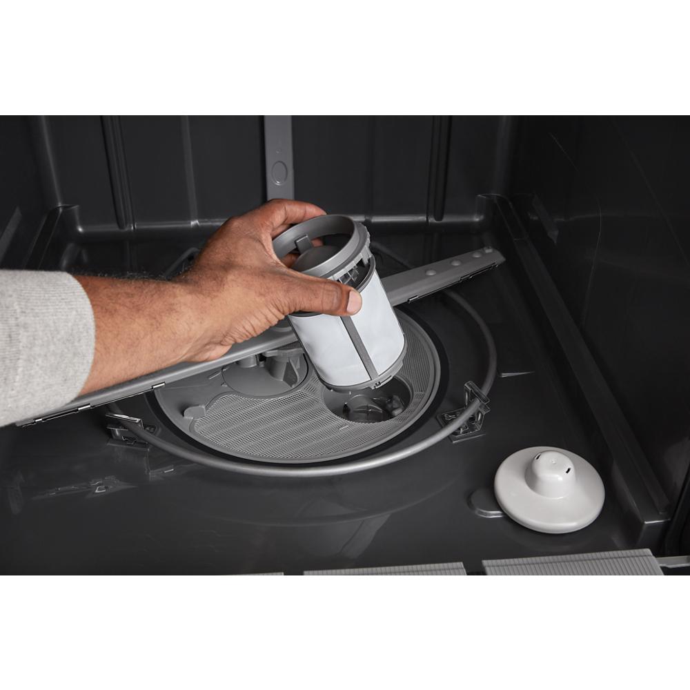 Hand removing filter from inside the bottom of a quiet dishwasher with 3rd rack in kitchen appliances collection