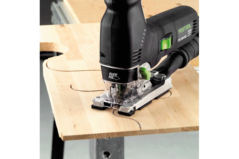 Festool power jigsaw cutting curved shapes in wood panel for woodworking tool accessories use