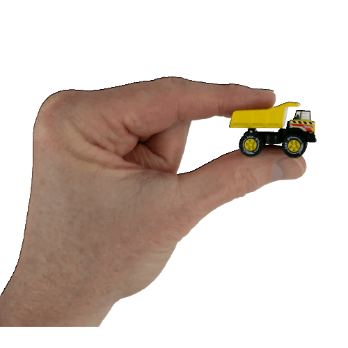 Hand holding a miniature yellow and black dump truck toy for home improvement and tools display use